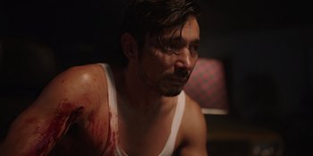 Movie still from “The Big 4” (2022), directed by Timo Tjahjanto – A person with blood on his shoulder; Close Up shot, Over the shoulder angle