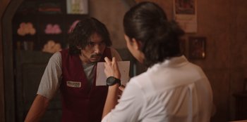 Movie still from “The Big 4” (2022), directed by Timo Tjahjanto – A man and a woman looking at each other in front of a mirror; Medium shot, Over the shoulder angle