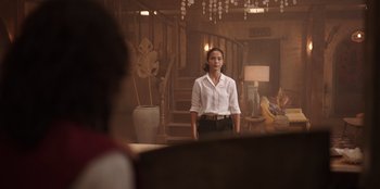 Movie still from “The Big 4” (2022), directed by Timo Tjahjanto – A woman standing in front of a mirror in a living room; Wide shot, Low angle