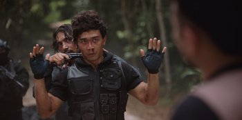 Movie still from “The Big 4” (2022), directed by Timo Tjahjanto – A man in a black jacket and a man in a black shirt; Medium shot, Over the shoulder angle