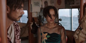 Movie still from “The Big 4” (2022), directed by Timo Tjahjanto – A woman with a tattoo on her arm standing next to a man; Medium shot, Over the shoulder angle