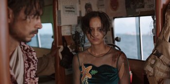 Movie still from “The Big 4” (2022), directed by Timo Tjahjanto – A woman with a star fish tattoo on her chest; Medium shot, Over the shoulder angle