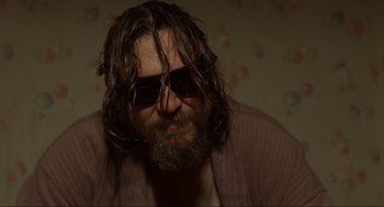 Movie still from “The Big Lebowski” (1998), directed by Ethan Coen – A person wearing sunglasses with long hair; Close Up shot, Low angle
