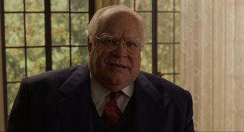 Movie still from “The Big Lebowski” (1998), directed by Ethan Coen – An older man wearing a suit and tie; Close Up shot, Over the shoulder angle