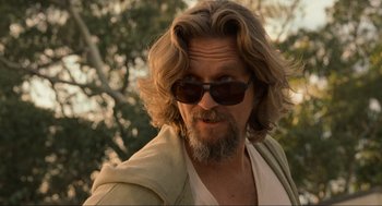 Movie still from “The Big Lebowski” (1998), directed by Ethan Coen – A person wearing sunglasses and a jacket; Close Up shot, Low angle