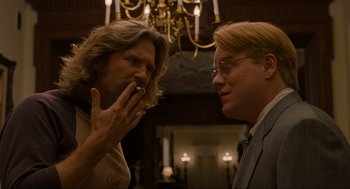 Movie still from “The Big Lebowski” (1998), directed by Ethan Coen – Two men are talking in front of a chandelier; Close Up shot, Over the shoulder angle