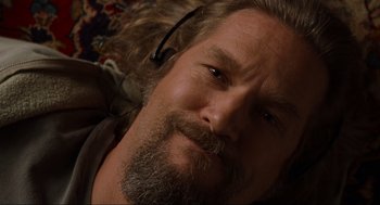 Movie still from “The Big Lebowski” (1998), directed by Ethan Coen – A person with a beard wearing headphones; Close Up shot, Overhead angle