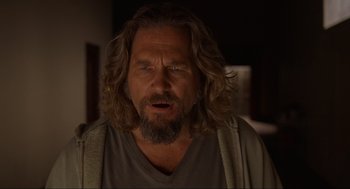 Movie still from “The Big Lebowski” (1998), directed by Ethan Coen – A person with long hair and a beard; Close Up shot, Over the shoulder angle