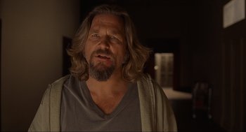 Movie still from “The Big Lebowski” (1998), directed by Ethan Coen – A person with long hair and a beard; Close Up shot, Over the shoulder angle