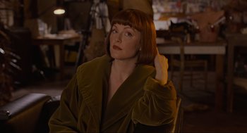 Movie still from “The Big Lebowski” (1998), directed by Ethan Coen – A woman sitting in a chair with her hand up to her head; Close Up shot, Over the shoulder angle