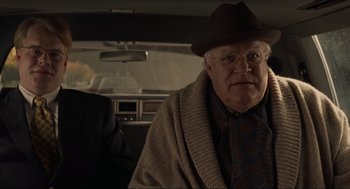 Movie still from “The Big Lebowski” (1998), directed by Ethan Coen – An older man wearing a hat and glasses in a car; Medium shot, Over the shoulder angle