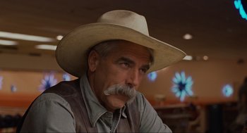 Movie still from “The Big Lebowski” (1998), directed by Ethan Coen – An older man wearing a cowboy hat with a mustache; Close Up shot, Over the shoulder angle