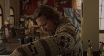 Movie still from “The Big Lebowski” (1998), directed by Ethan Coen – A man with long brown hair wearing a sweater; Medium shot, Over the shoulder angle