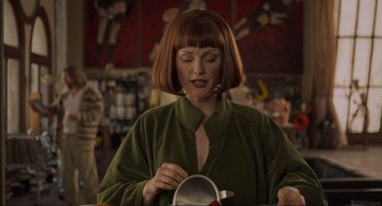 Movie still from “The Big Lebowski” (1998), directed by Ethan Coen – A woman in a green robe is looking at a bowl; Medium shot, Low angle