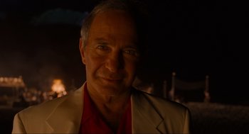 Movie still from “The Big Lebowski” (1998), directed by Ethan Coen – An older man wearing a red shirt and a tan jacket; Close Up shot, Over the shoulder angle