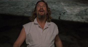 Movie still from “The Big Lebowski” (1998), directed by Ethan Coen – A man with long hair and a white shirt is looking up; Medium shot, Low angle