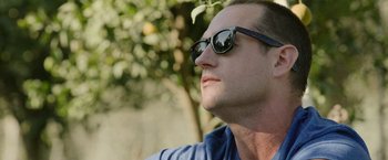 Movie still from “The Biggest Little Farm: The Return” (2022), directed by John Chester – A person wearing sunglasses; Close Up shot, Low angle