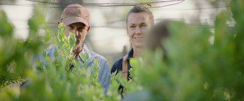 Movie still from “The Biggest Little Farm: The Return” (2022), directed by John Chester – A man and a woman standing next to each other; Close Up shot, Low angle