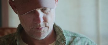 Movie still from “The Biggest Little Farm: The Return” (2022), directed by John Chester – A person wearing a hat; Close Up shot, Low angle