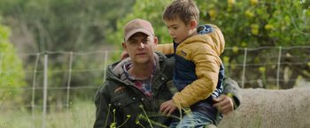 Movie still from “The Biggest Little Farm: The Return” (2022), directed by John Chester – A man and a boy sitting on his shoulders; Medium shot, Low angle