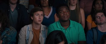 Movie still from “The Binge” (2020), directed by Jeremy Garelick – A group of young men sitting in front of a crowd; Close Up shot, High angle