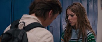 Movie still from “The Binge” (2020), directed by Jeremy Garelick – A man and a woman standing next to each other in front of lockers; Medium shot, Over the shoulder angle