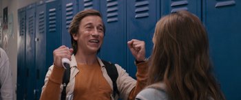 Movie still from “The Binge” (2020), directed by Jeremy Garelick – A man and a woman standing in front of lockers; Medium shot, Low angle