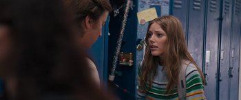 Movie still from “The Binge” (2020), directed by Jeremy Garelick – A young woman looking at a young man in the mirror; Medium shot, Over the shoulder angle