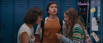Movie still from “The Binge” (2020), directed by Jeremy Garelick – A group of people standing next to each other in front of lockers; Medium shot, Low angle
