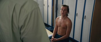 Movie still from “The Binge” (2020), directed by Jeremy Garelick – A man sitting in front of a mirror in a locker room; Medium shot, Over the shoulder angle