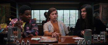 Movie still from “The Binge” (2020), directed by Jeremy Garelick – A man sitting at a table with a glass of beer; Medium shot, Over the shoulder angle