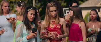 Movie still from “The Binge” (2020), directed by Jeremy Garelick – A group of people standing around each other; Close Up shot, Over the shoulder angle