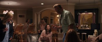 Movie still from “The Binge” (2020), directed by Jeremy Garelick – A group of people gathered in a living room; Medium shot, Over the shoulder angle