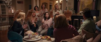 Movie still from “The Binge” (2020), directed by Jeremy Garelick – A group of women sitting around a table with food; Wide shot, High angle