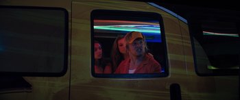 Movie still from “The Binge” (2020), directed by Jeremy Garelick – Two women and a man in the back of a car; Medium shot, Low angle