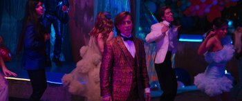 Movie still from “The Binge” (2020), directed by Jeremy Garelick – A group of young people dancing in front of a purple background; Medium shot, Over the shoulder angle