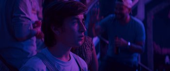 Movie still from “The Binge” (2020), directed by Jeremy Garelick – A young man looking up into the air; Close Up shot, Over the shoulder angle