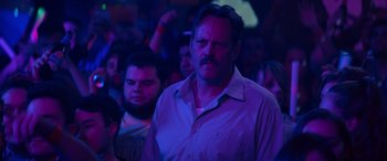 Movie still from “The Binge” (2020), directed by Jeremy Garelick – A group of people in a dark room with purple lighting; Close Up shot, Low angle