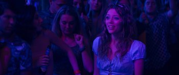 Movie still from “The Binge” (2020), directed by Jeremy Garelick – A group of young people sitting in front of a purple light; Medium shot, Low angle