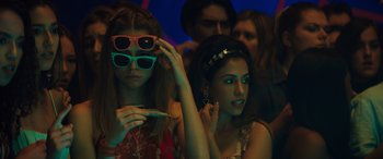 Movie still from “The Binge” (2020), directed by Jeremy Garelick – A group of young people sitting together in a room; Medium shot, Over the shoulder angle