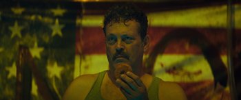 Movie still from “The Binge” (2020), directed by Jeremy Garelick – A person eating a doughnut; Close Up shot, Low angle