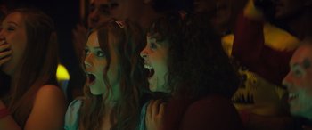 Movie still from “The Binge” (2020), directed by Jeremy Garelick – Two women are laughing together at a party; Close Up shot, Low angle