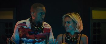 Movie still from “The Binge” (2020), directed by Jeremy Garelick – A man and a woman wearing headphones and talking to each other; Close Up shot, Low angle