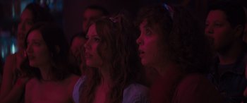 Movie still from “The Binge” (2020), directed by Jeremy Garelick – Two women are watching something in a dark room; Close Up shot, Low angle