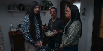 Movie still from “It's A Wonderful Binge” (2022), directed by Jordan VanDina – A group of people standing in a room; Medium shot, High angle