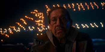 Movie still from “It's A Wonderful Binge” (2022), directed by Jordan VanDina – An old man with a beard and a jacket is looking into the camera; Close Up shot, Low angle