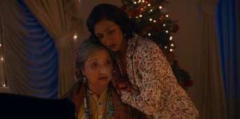 Movie still from “It's A Wonderful Binge” (2022), directed by Jordan VanDina – A woman and an older woman standing next to a christmas tree; Close Up shot, Over the shoulder angle