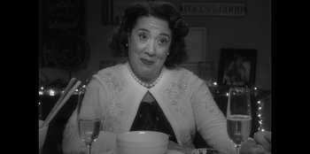 Movie still from “It's A Wonderful Binge” (2022), directed by Jordan VanDina – A woman sitting at a table with a bowl of soup; Close Up shot, Over the shoulder angle