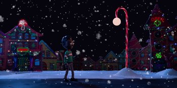 Movie still from “It's A Wonderful Binge” (2022), directed by Jordan VanDina – A boy standing next to a street light in the snow at night; Extreme Wide shot, High angle