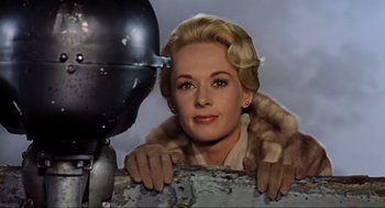 Movie still from “The Birds” (1963), directed by Alfred Hitchcock – A woman in a fur coat leaning on a metal object; Close Up shot, Low angle
